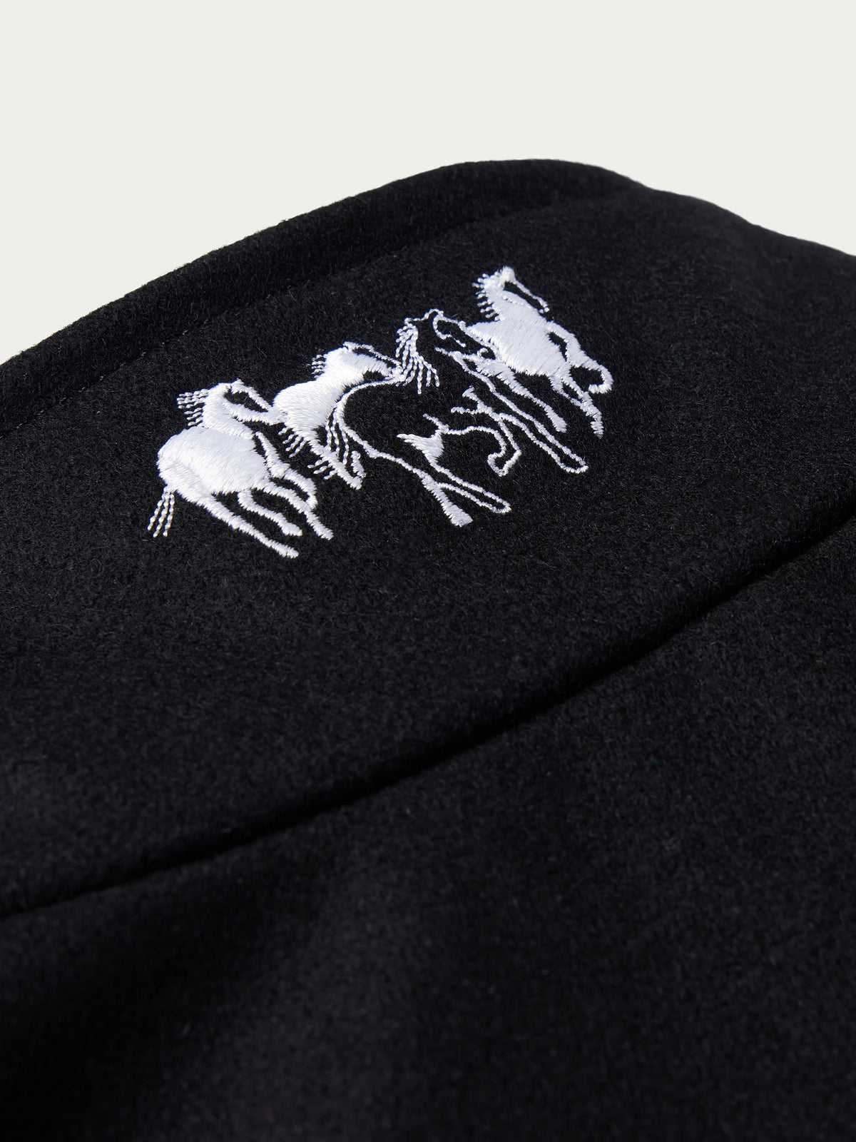 Black wool arena jacket with white embroidered crest logo on chest