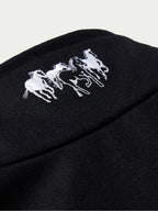 Black wool vest close-up with white and blue embroidered horse logo on shoulder