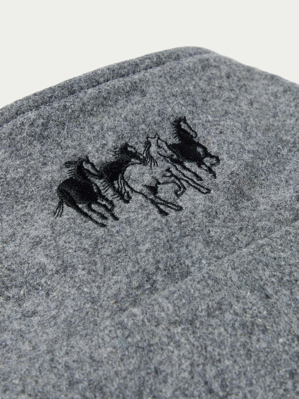 Heather gray wool vest with black horse logo embroidery on chest.