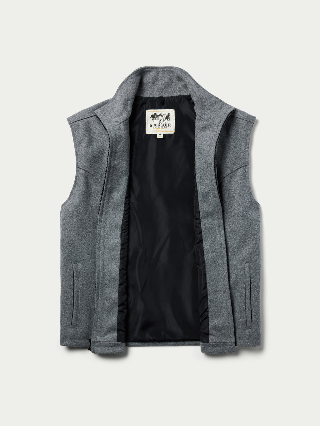 Heather gray wool zip vest with dark interior lining and brand label at collar.