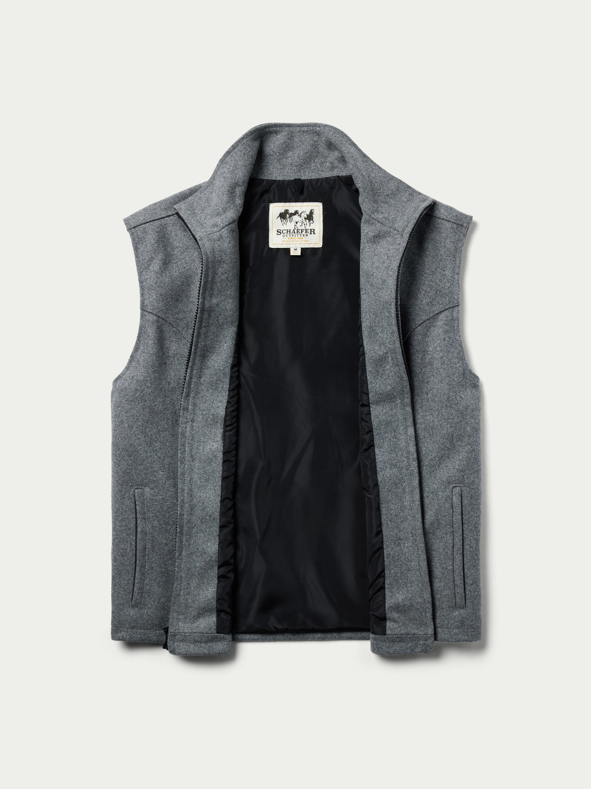Heather gray wool zip vest with dark interior lining and brand label at collar.