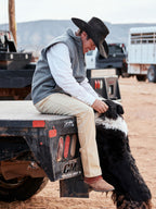 Heather gray wool arena vest with stand collar and front zipper, worn outdoors.