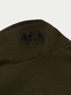 Loden wool arena vest shoulder detail with small embroidered logo.