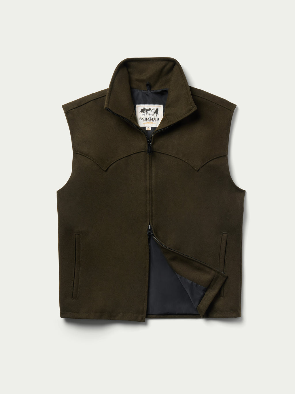 Loden wool arena vest with stand collar, full zip, and dark interior lining pocket.