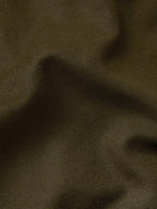 Loden wool fabric close-up with fine woven texture.
