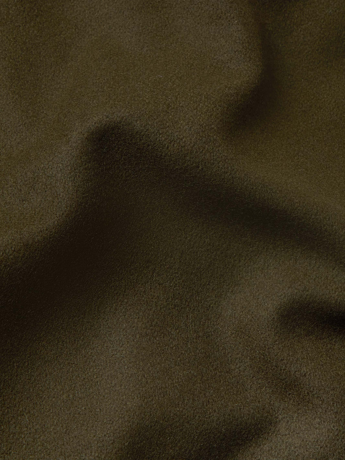 Loden wool fabric close-up with fine woven texture.