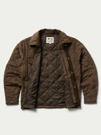 Brown quilted microsuede jacket on model, showing stand collar and snap-front design.
