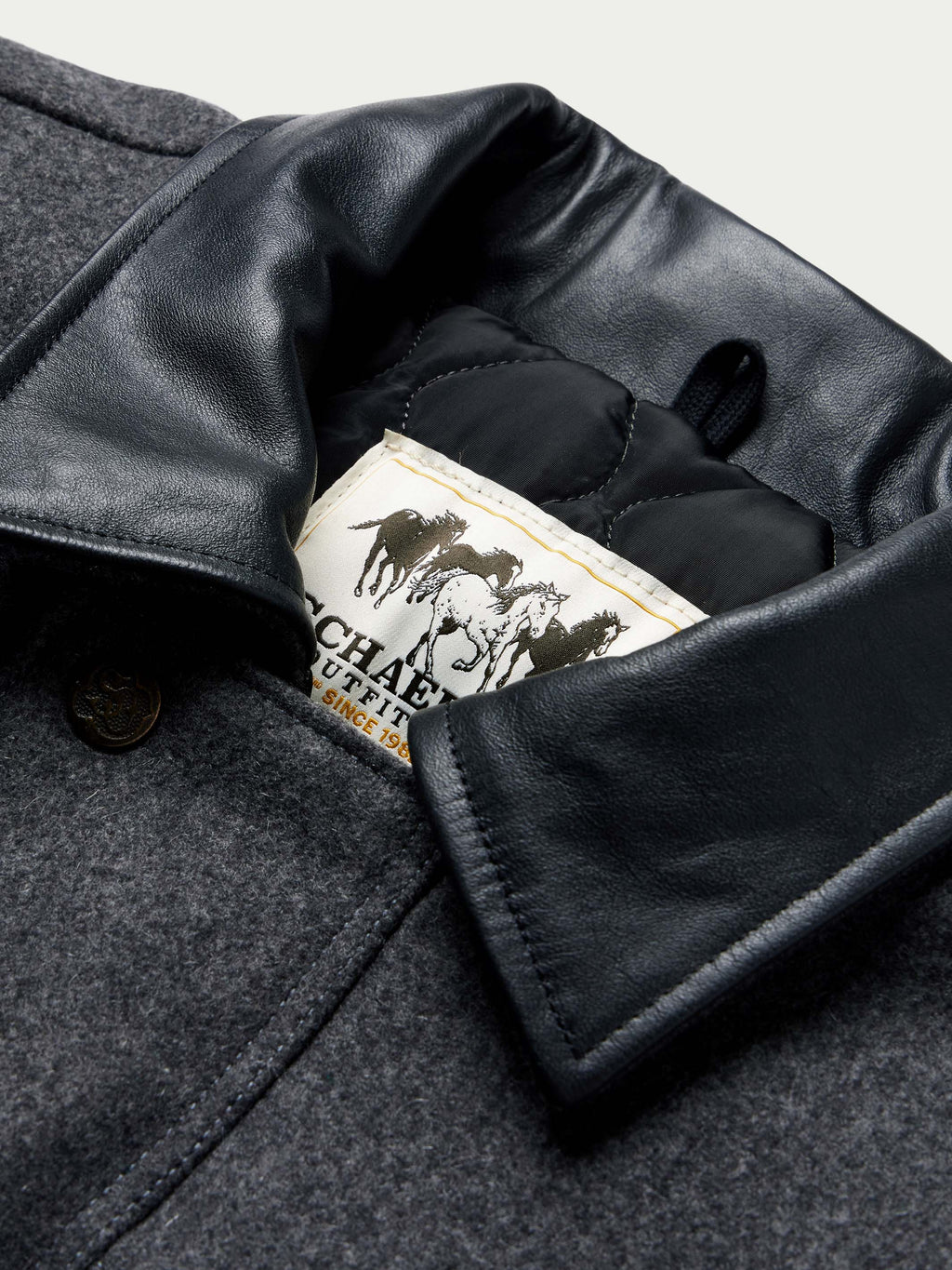 Charcoal wool coat collar lining with black leather trim and Cattle King label