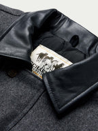 Charcoal wool coat collar lining with black leather trim and Cattle King label
