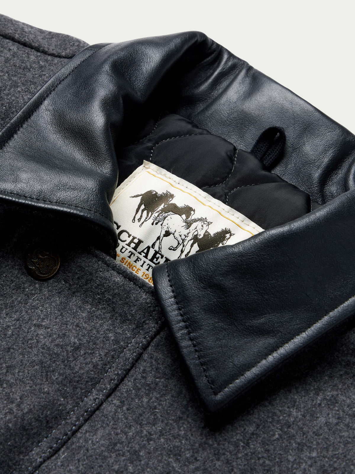 Charcoal wool coat collar lining with black leather trim and Cattle King label