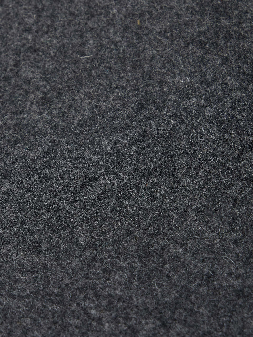 Charcoal wool fabric texture close-up with subtle speckling