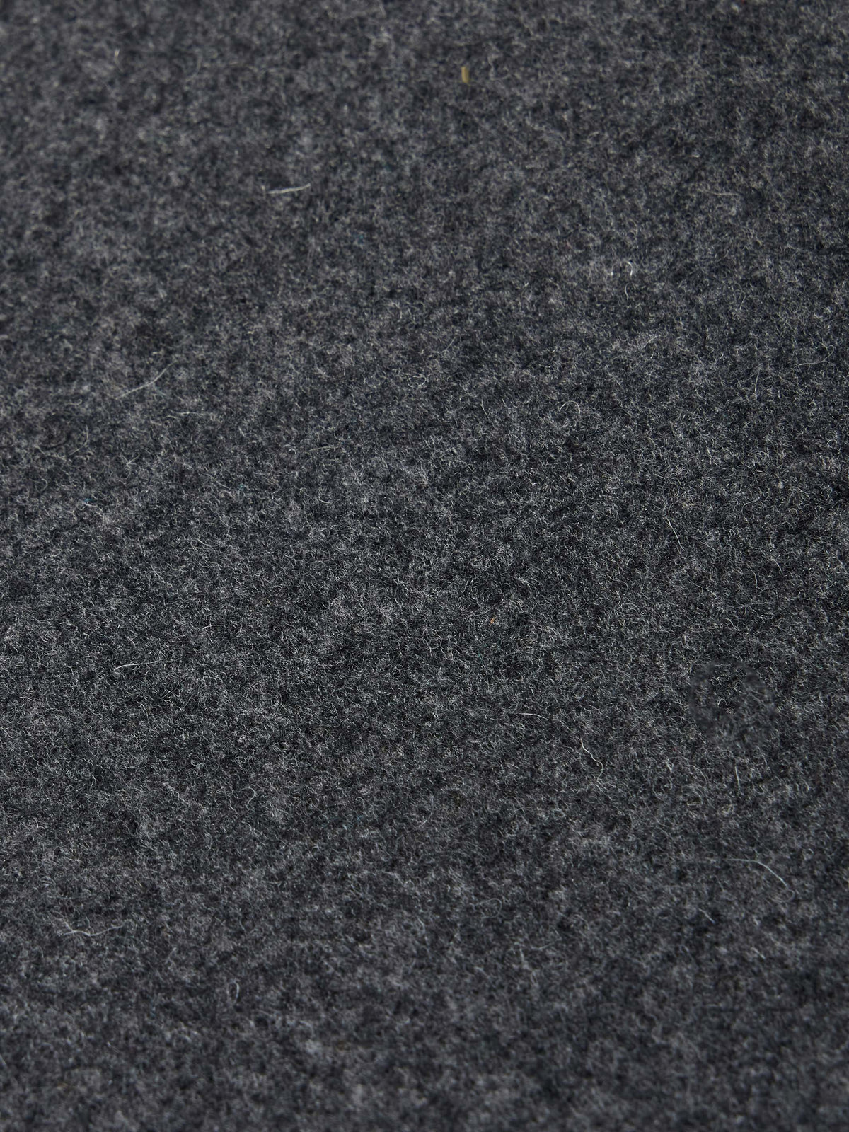 Charcoal wool fabric texture close-up with subtle speckling