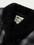 Black wool coat with shearling-style collar, interior label visible