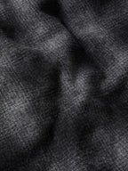Black wool fabric close-up with soft texture and curved seam lines