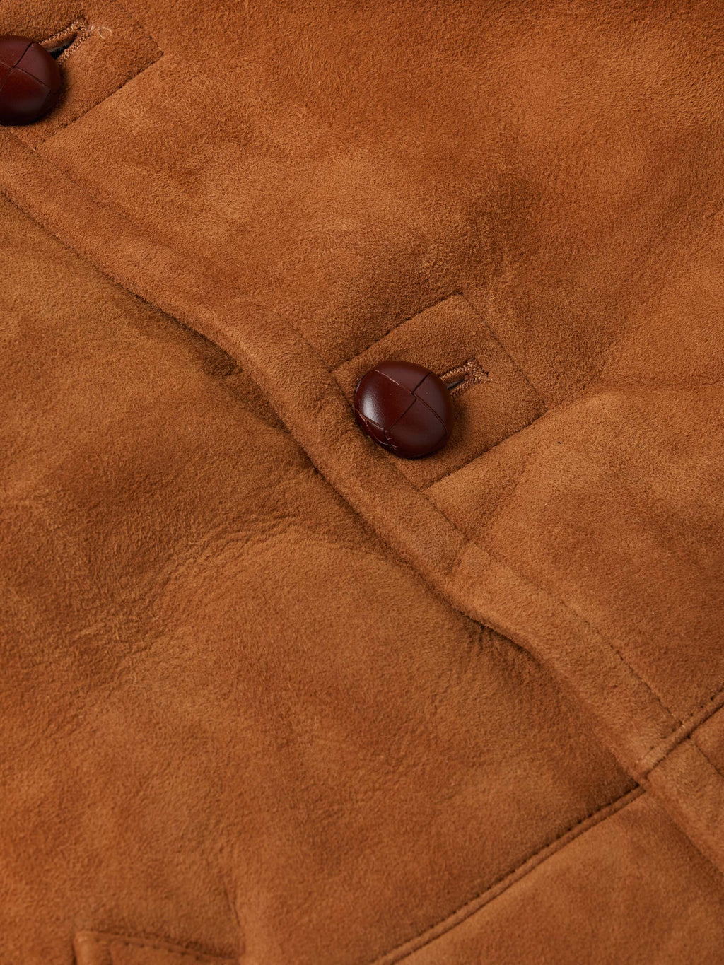 Brown suede shearling coat detail with button placket and soft shearling lining
