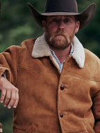 Buckskin shearling coat close-up with white shearling trim and dark button placket
