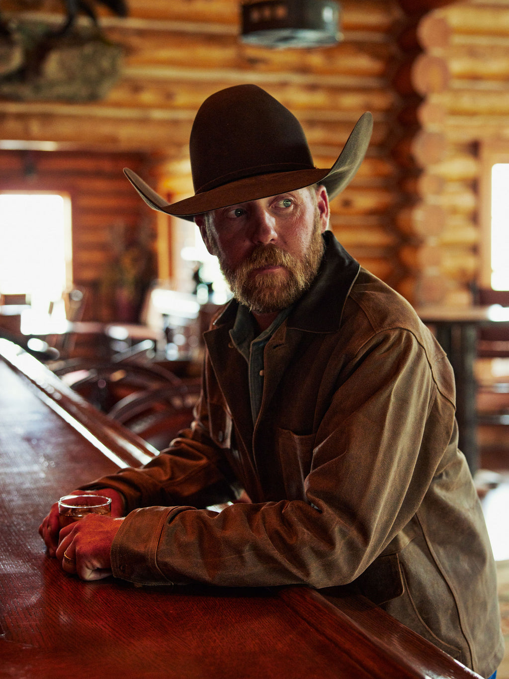 Brown brush jacket with snap front, flap pockets, and stand collar