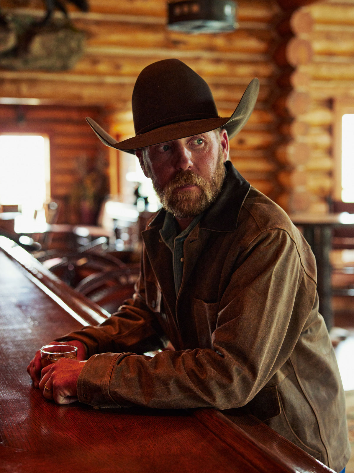 Brown brush jacket with snap front, flap pockets, and stand collar