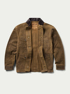 Tan leather brush jacket front view with flap pockets and snap buttons, dark collar.