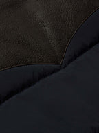 Brown leather-look shoulder panel and navy quilted puffer section