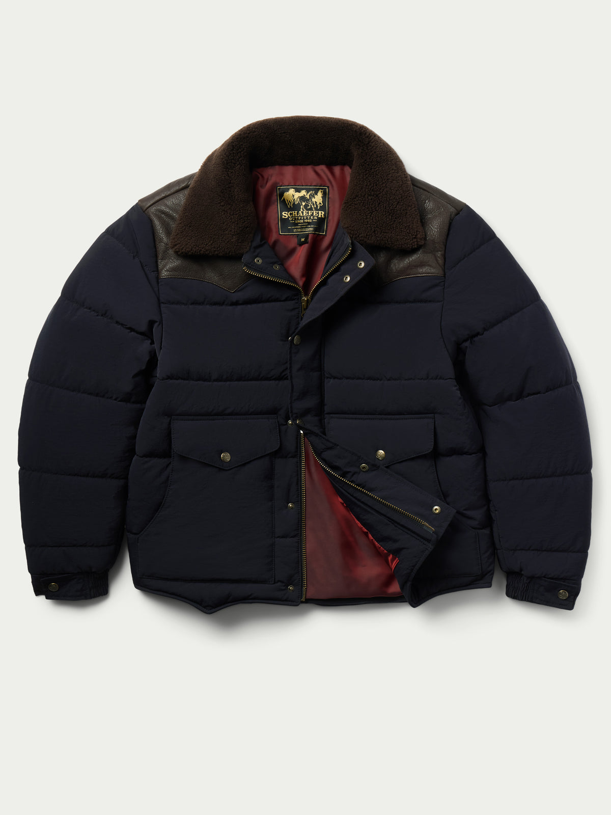 Navy puffer jacket with brown sherpa lining collar, front view with flap open