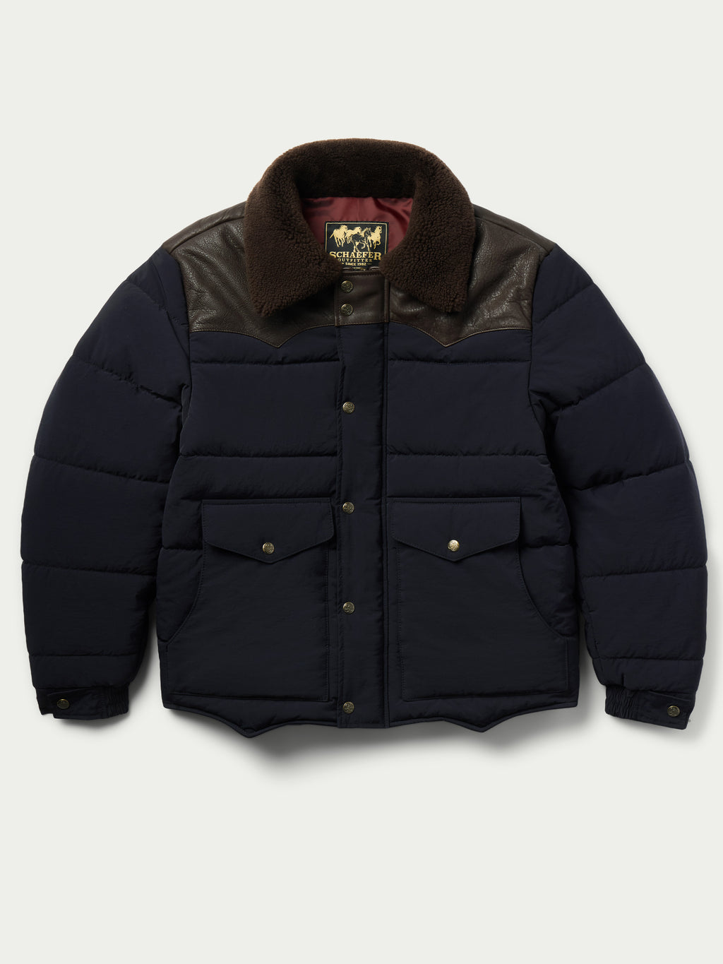 Navy puffer jacket with brown sherpa collar, snap-up front and buttoned chest pockets
