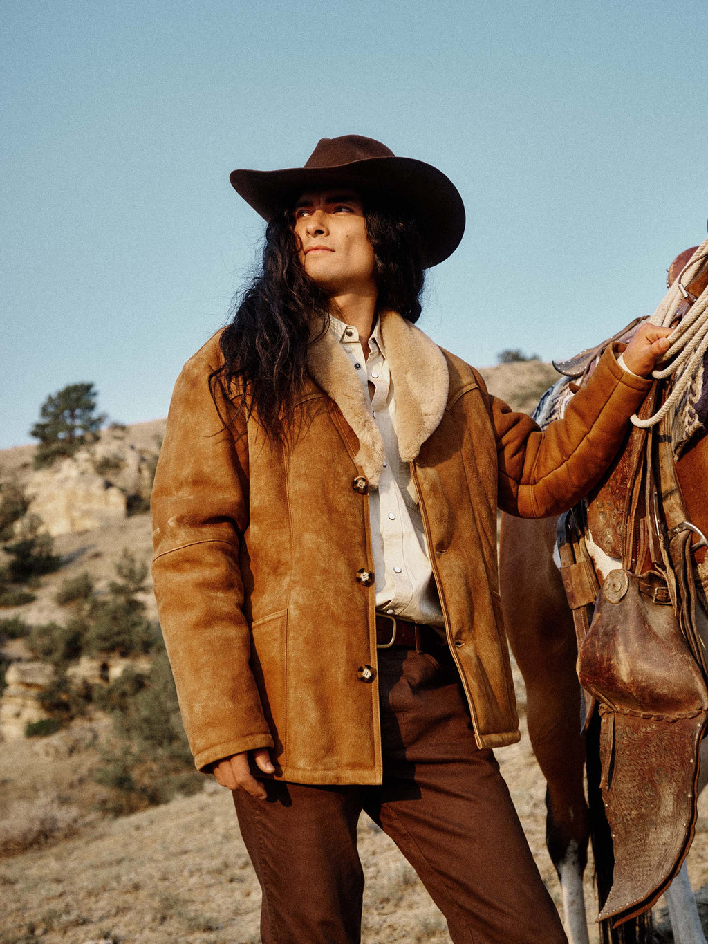 Tan-brown shearling coat with plush cream collar, front buttons, long sleeves