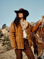Tan-brown shearling coat with plush cream collar, front buttons, long sleeves