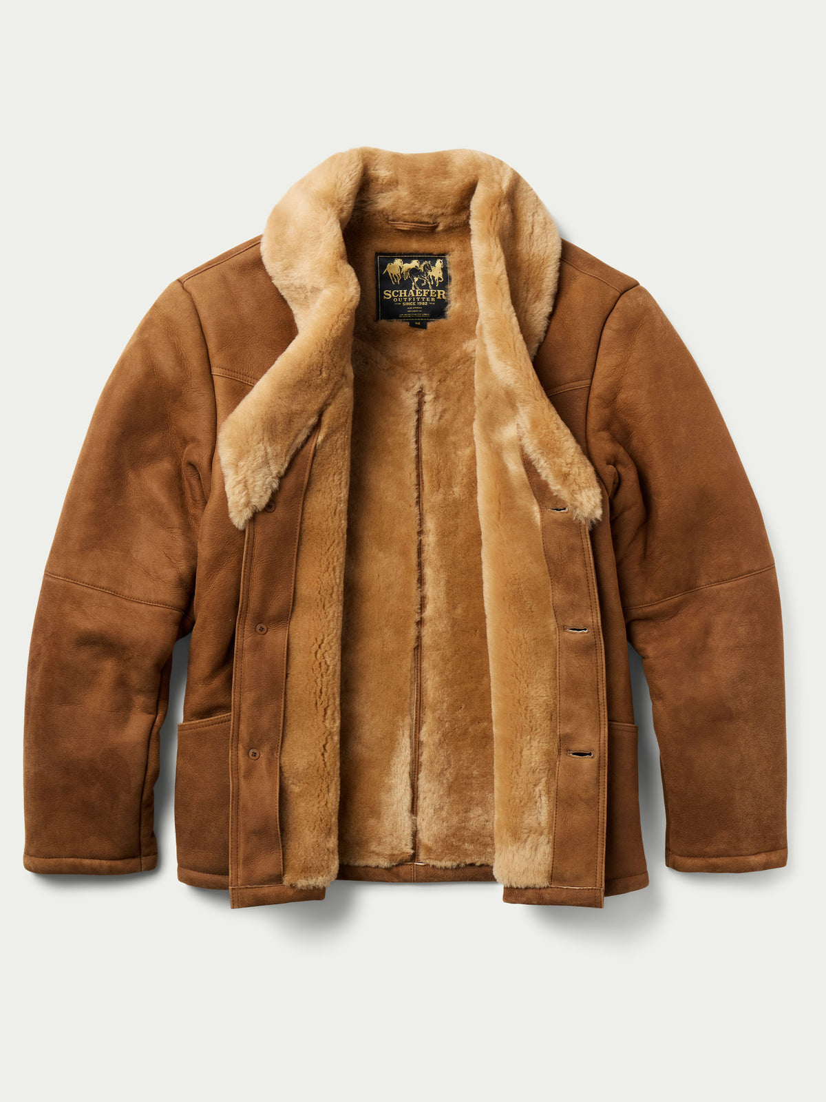 Brown shearling coat with plush collar, snap buttons, and warm fleece lining.