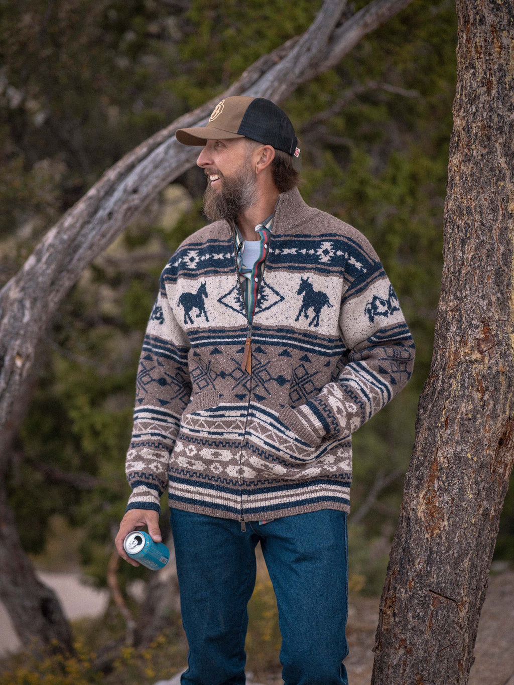 Fair Isle full-zip sweater in brown with navy horse motifs, worn on a person.