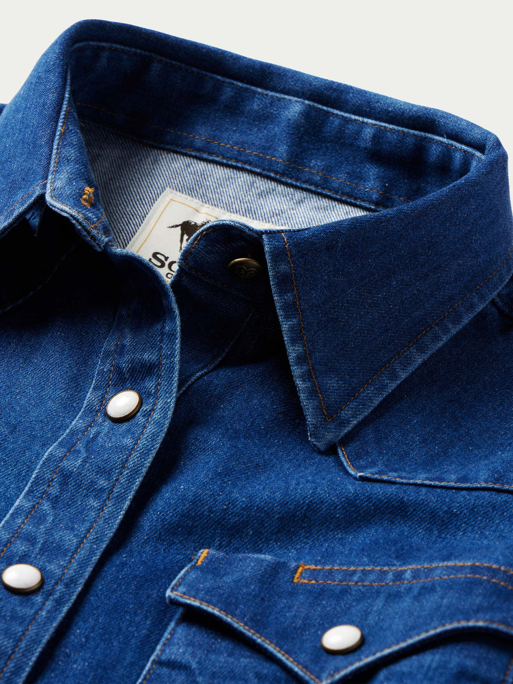 Indigo denim western shirt collar with pearl snap placket and contrast stitching