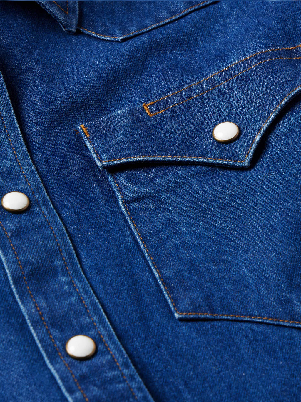 Indigo denim chest pocket with pearl snap and contrast-stitched flap