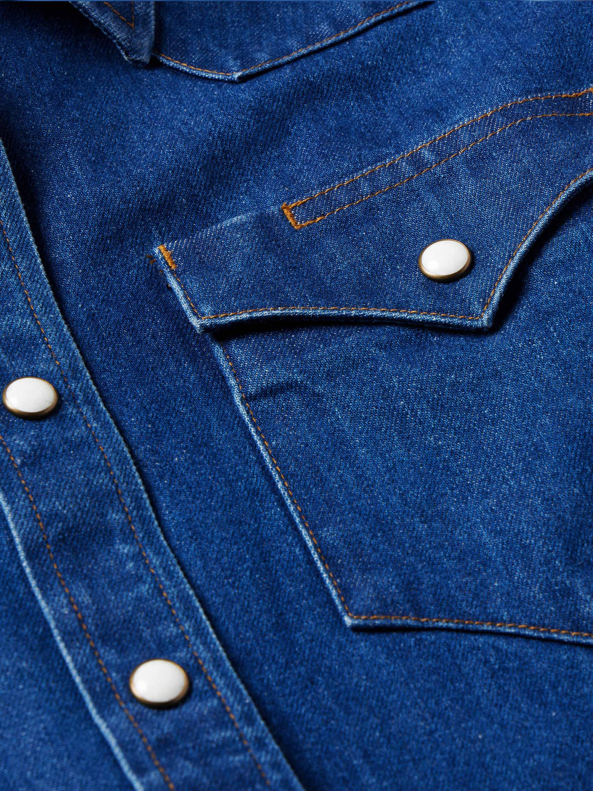 Indigo denim chest pocket with pearl snap and contrast-stitched flap