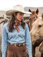 Light wash denim western shirt with pearl snap buttons and chest flap pockets