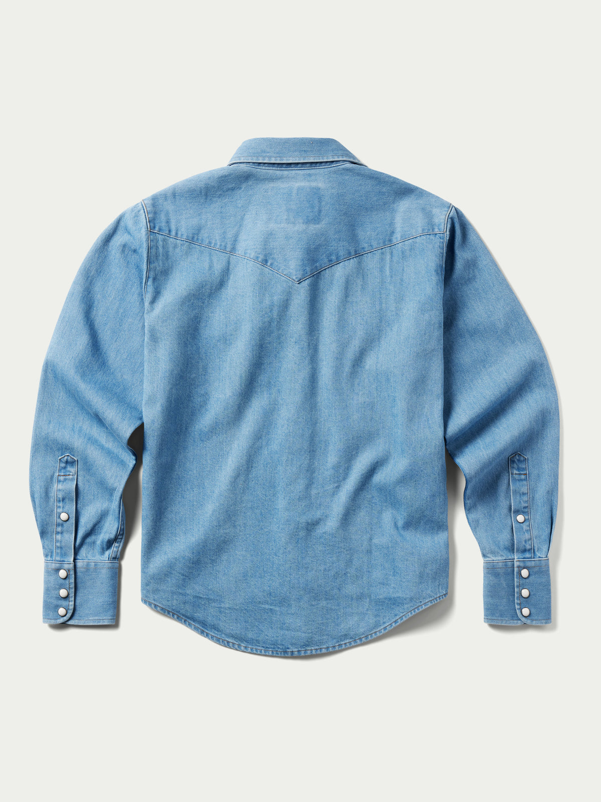 Light wash women's denim pearl snap western shirt, back view, long sleeves