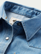 Light wash denim western shirt neckline with pearl snap placket and yoke seam