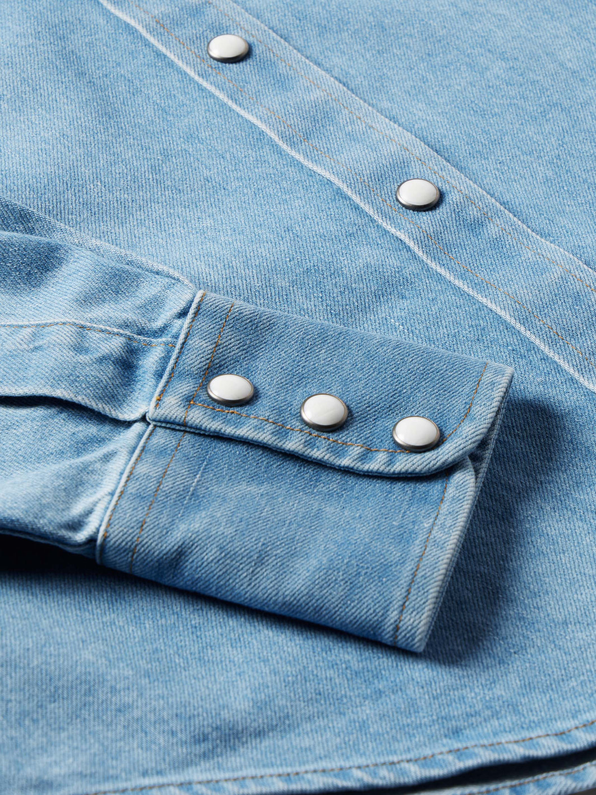Light wash denim western shirt with pearl snap cuff and single button tab