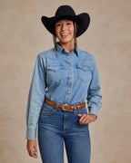 Light wash denim western snap shirt with flap chest pockets and pearl snap buttons