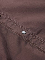 Faded maroon denim snap placket detail with metal snap buttons