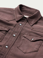 Faded maroon western snap shirt with buttoned chest pockets and collared neckline