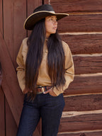 Women wearing faded chestnut denim snap shirt with chest pockets and snap placket