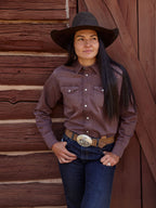 Faded maroon western denim snap shirt with chest pockets and long sleeves