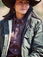 Faded maroon snap-button western shirt collar and front placket detail