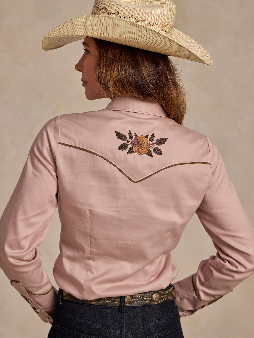 Back view of desert rose embroidered snap shirt with floral yoke detail