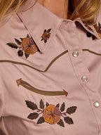 Desert rose embroidered snap shirt close-up with floral motifs and green trim