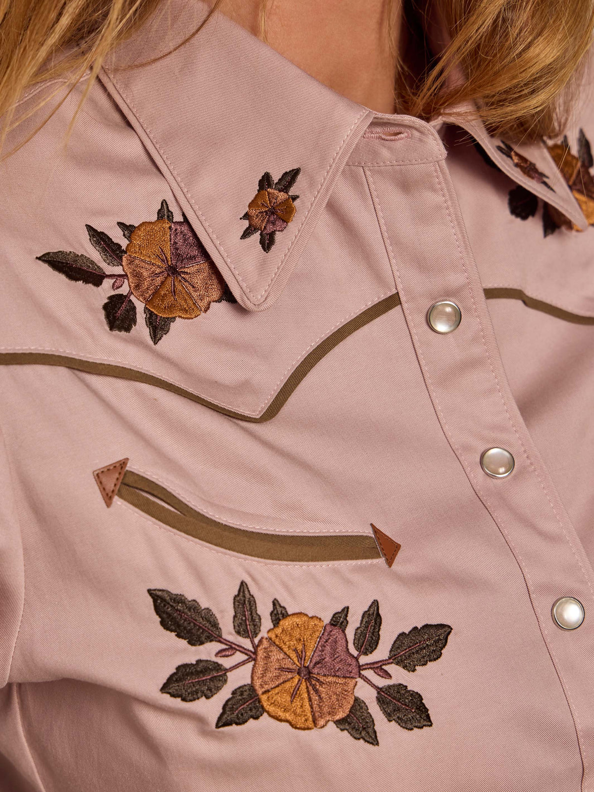 Desert rose embroidered snap shirt close-up with floral motifs and green trim