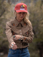Chestnut-brown embroidered snap shirt on model, front view with floral chest embroidery