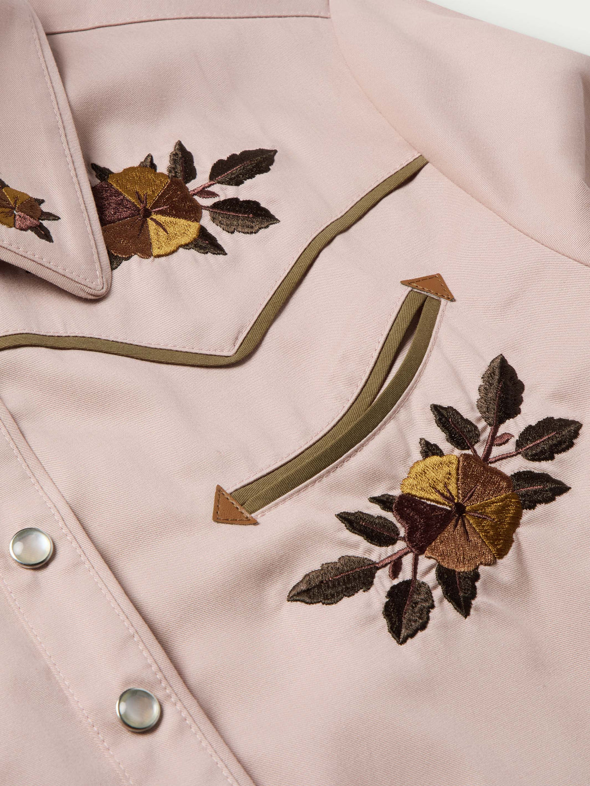 Desert rose embroidered snap shirt detail with floral chest motif and green piping trim