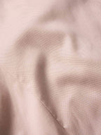 Desert rose fabric close-up of embroidered snap shirt texture and stitching