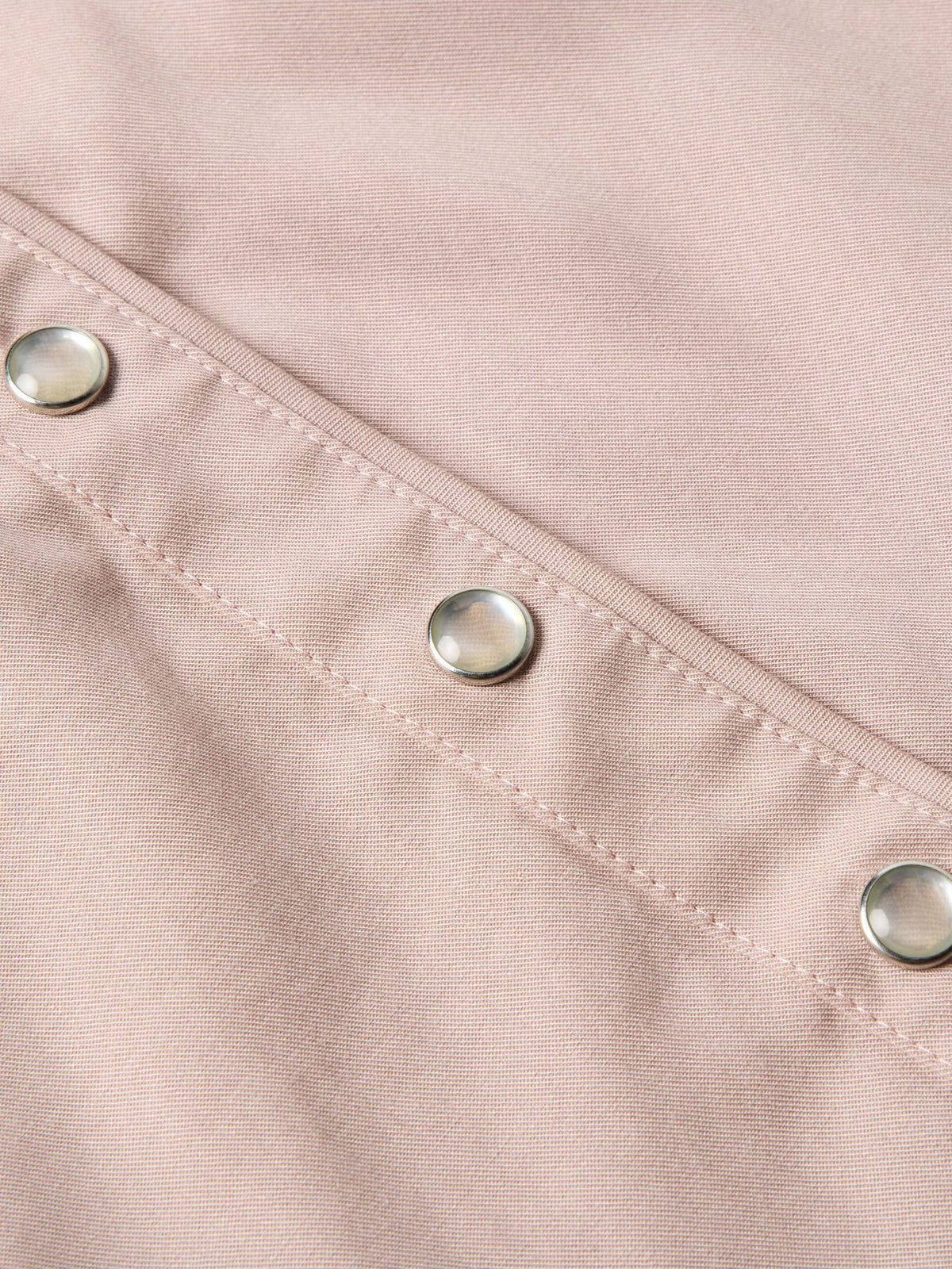 Desert rose shirt close-up of seam and silver snap buttons on cuff placket